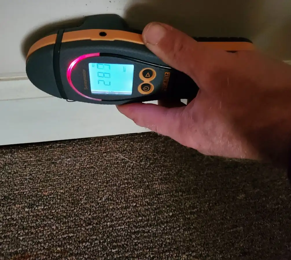 Moisture detection at baseboard during Storm Damage Restoration in Telford